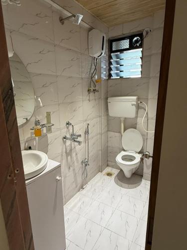 a bathroom with a toilet and a sink at Ikigai 2Bhk Furnished Apartment Soothing Vibes in Navi Mumbai