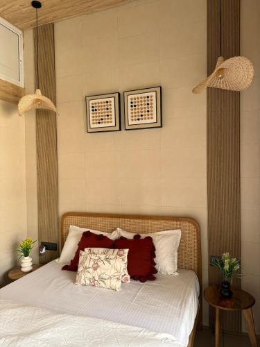 a bedroom with a bed and two pictures on the wall at Ikigai 2Bhk Furnished Apartment Soothing Vibes in Navi Mumbai