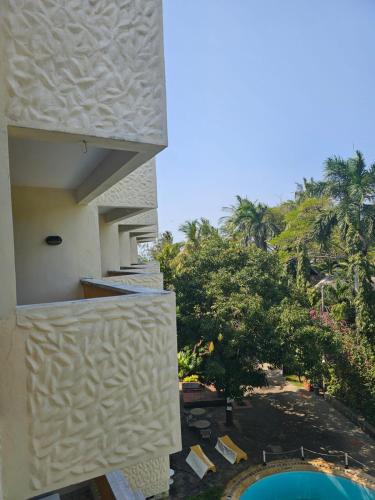 a view from the balcony of a building with a pool at Indiana Beach Apartments in Bamburi