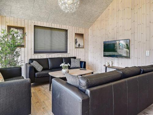 a living room with leather furniture and a tv at 5 star holiday home in Kappeln in Kappeln
