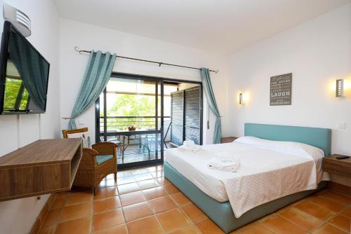 a bedroom with a bed and a table and a window at Marina Hill Apartment in Lagos
