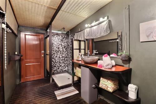 a bathroom with a sink and a mirror at Fare Vainina beach house in Moorea