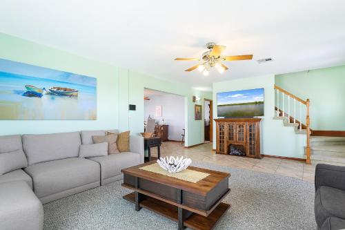 a living room with a couch and a table at Bayou Manor in Slidell