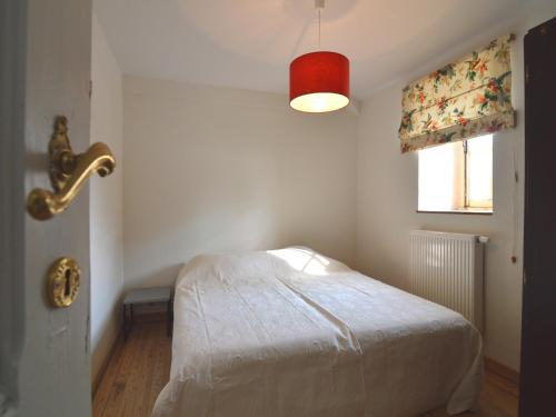 a bedroom with a white bed and a window at Peaceful Retreat in Roumont in Roumont