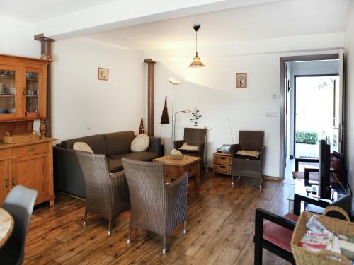 a living room with a couch and a table at Farmhouse appartment in Eede in Eede