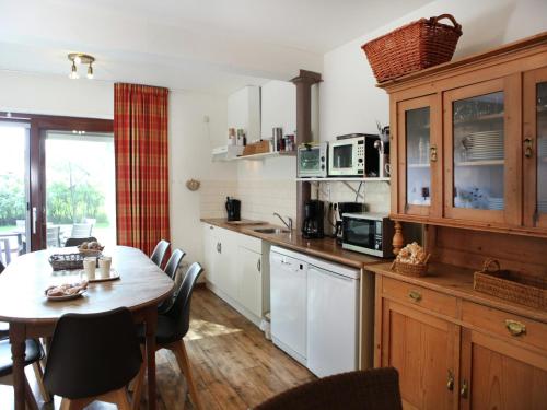 a kitchen with a table and a table and chairs at Farmhouse appartment in Eede in Eede