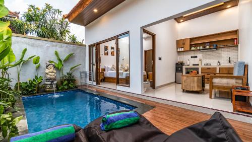 an indoor swimming pool in the middle of a house at Taman Kencana Ubud in Ubud