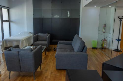 a living room with two couches and a table at Cosy & Bright European Uni Apt in Strovolos