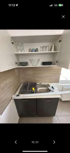 a kitchen with a sink and a counter top at Budget Rooms Köflach in Köflach