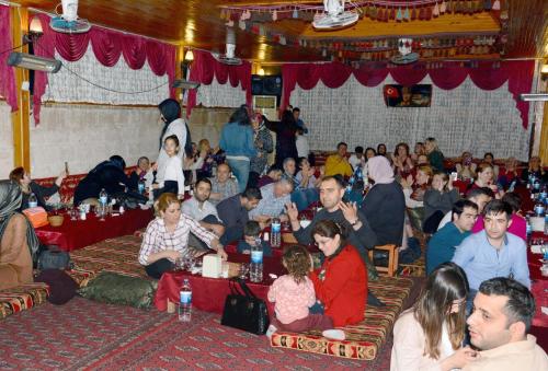 a large group of people sitting in a room at yıldız saray konuk evi in Sanlıurfa