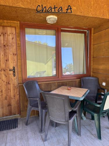 a table and chairs in a room with a window at ATC Apollo Lednice in Břeclav
