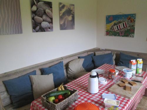 a table with a red and white checkered table cloth at Bungalow in France near Castle & Hiking Trails in La Chapelle-sur-Dun