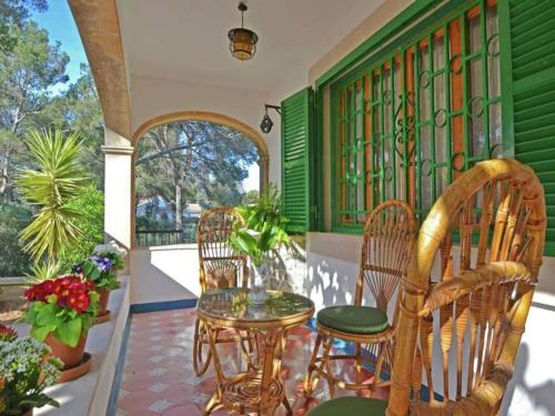 a patio with chairs and a table on a porch at Chalet in El Toro with Pool by the Ocean in El Toro