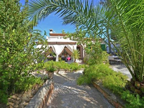 a house with a tent in the middle of a garden at Chalet in El Toro with Pool by the Ocean in El Toro
