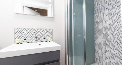 a bathroom with a white sink and a shower at The Clarence Gardens Hotel, BW Signature Collection in Scarborough