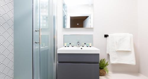 a bathroom with a sink and a shower at The Clarence Gardens Hotel, BW Signature Collection in Scarborough