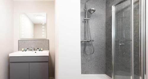 a bathroom with a shower and a sink at The Clarence Gardens Hotel, BW Signature Collection in Scarborough