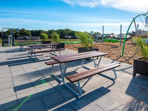 a group of picnic benches in a playground at Luxury Retreat in Mommark - By Traum Ferienwohnungen in Sarup