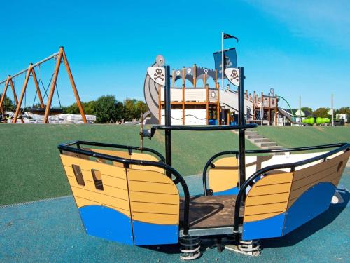 a playground with a slide in a park at Luxury Retreat in Mommark - By Traum Ferienwohnungen in Sarup