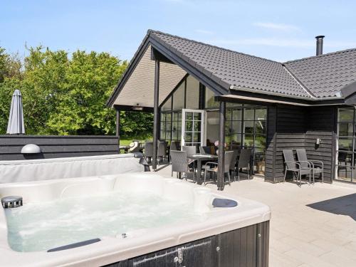 a hot tub in the backyard of a house at Luxury Retreat in Mommark - By Traum Ferienwohnungen in Sarup