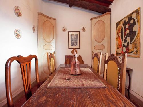 a dining room with a wooden table and chairs at Apartment Tuscany near Pratomagno Mountain in Pian di Scò