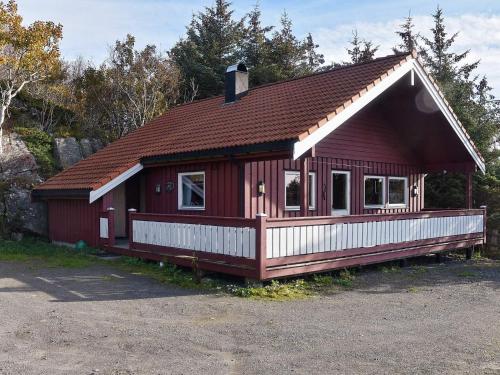 a small red house with a brown roof at 6 person holiday home in Bud in Bud