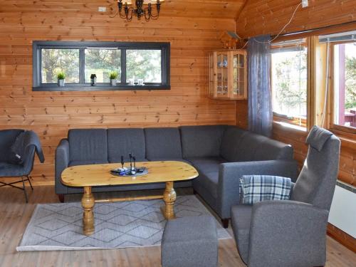 a living room with a couch and a table at 6 person holiday home in Bud in Bud