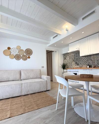a living room with a couch and a table at Calèma Apartments in Villasimius