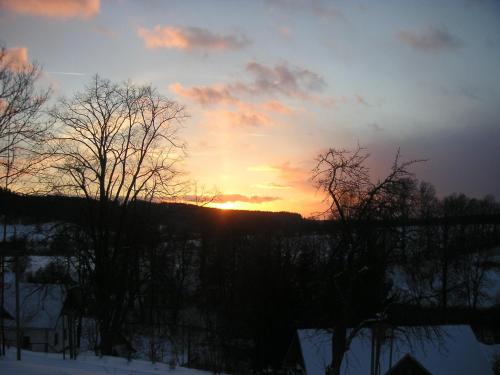 a sunset seen from the window of a house at Holiday Home in Javorník near Krkonose Park in Rudník