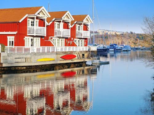 a row of houses on a dock next to a body of water at 7 person holiday home in STRöMSTAD in Strömstad