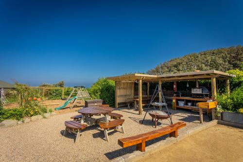 a picnic area with a picnic table and a playground at Luxury Glampsite with Sea Views in St Peter