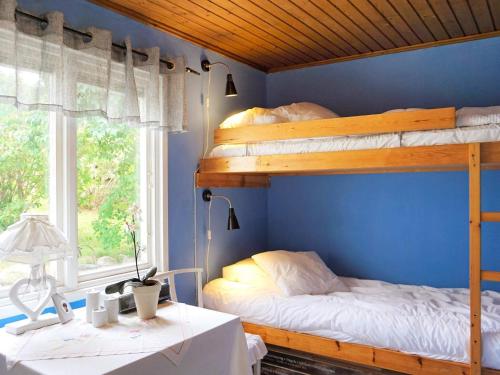 a bedroom with two bunk beds and a desk at 5 person holiday home in Uddevalla in Uddevalla