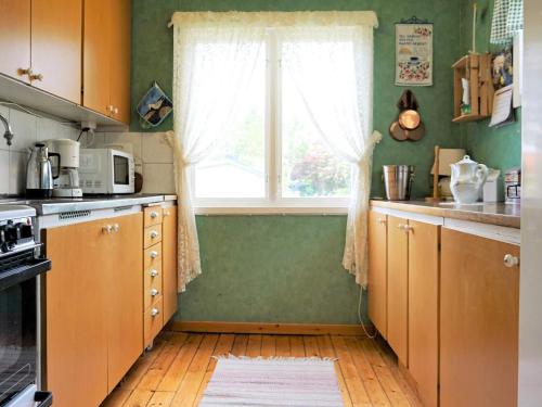 a kitchen with green walls and a window at 5 person holiday home in Uddevalla in Uddevalla