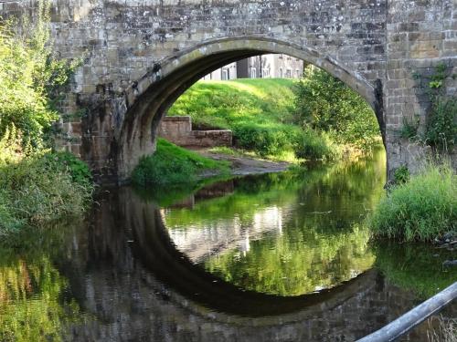 an old stone bridge over a river at Cottage in Jedburgh with Stunning Views in Jedburgh