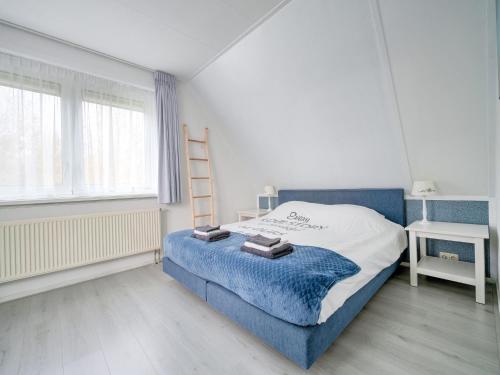 a bedroom with a bed and a ladder in it at Holiday Home in Zeewolde near Forest in Zeewolde