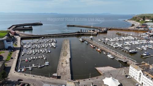 an aerial view of a marina with boats in the water at Coastal Haven - Steps From Beach in Whitehaven