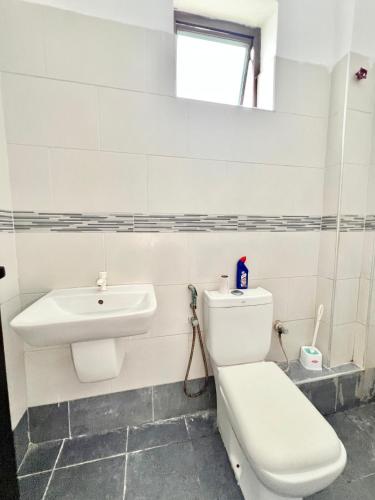a bathroom with a toilet and a sink at Saka Homes, Cozy 1-BR Bamburi in Mombasa