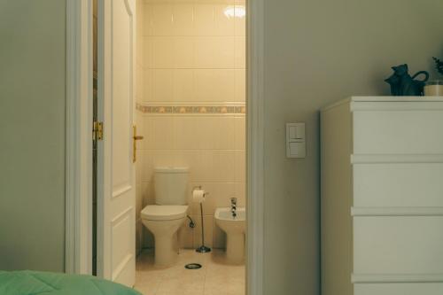 a bathroom with a toilet and a sink at Wicalia ShortStays in Mem Martins