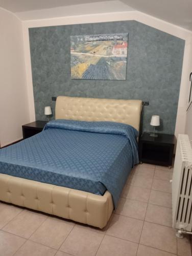 a bedroom with a bed with a blue comforter at Residence Hotel Azzurro in LʼAquila