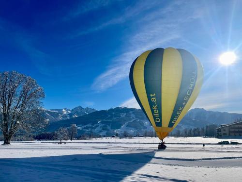 a hot air balloon in a snow covered field at Pension Möslehnerhof in Ramsau am Dachstein