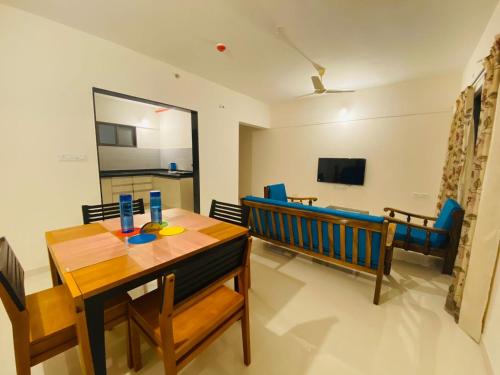 a dining room with a table and a bench at Petal Stay coliving in Pune