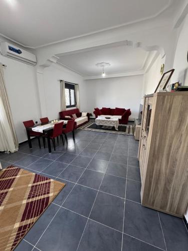 a living room with a couch and a table at Large villa & pool in Mosta in La Celle-sous-Gouzon