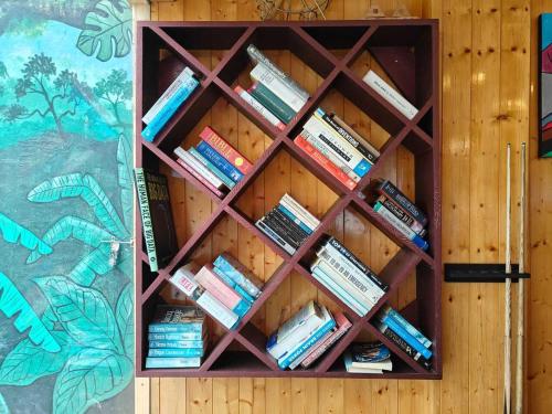 a shelf of books in a wooden wall at Amaira Resort & Farms - Mirik, West Bengal in Mirik