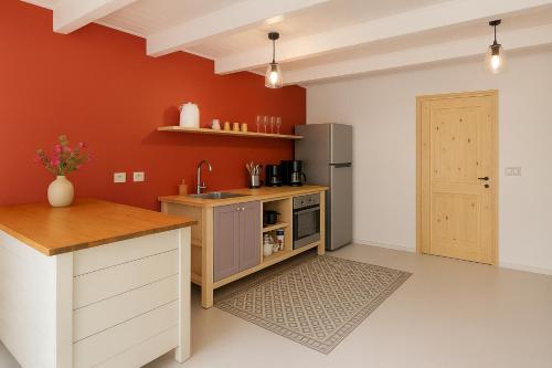 a kitchen with a sink and a refrigerator at The Green Turtle Eco Lodge in Willemstad