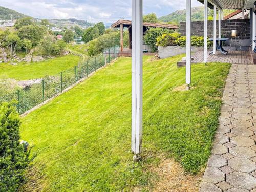 a pole in the grass next to a house at 4 person holiday home in EGERSUND-By Traum in Egersund