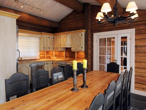 a dining room with a table and a kitchen at 4 star holiday home in Fåvang in Favang