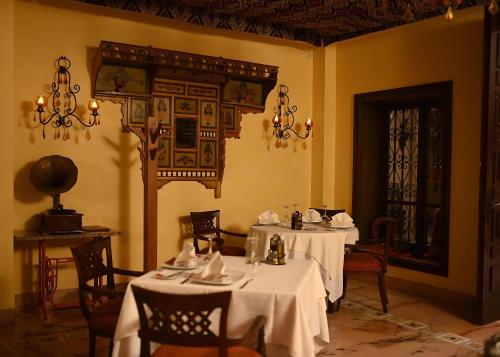a dining room with two tables with white table cloth at Borj Dhiafa in Sfax