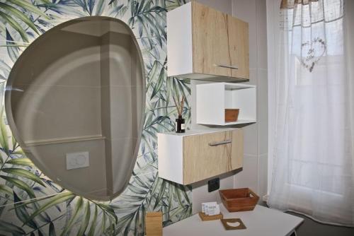 a mirror on a wall in a room with a table at Da Santa - Center, Fiera Rho, Malpensa, Milan, Laghi in Legnano