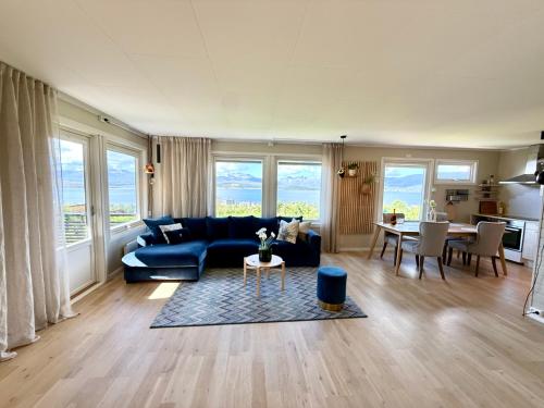 a living room with a blue couch and a table at Top location - Amazing views in Tromsø