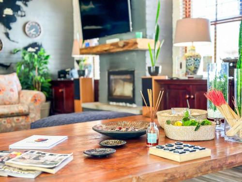 a wooden table with bowls of food on top of it at 3 on Pine, Luxury Home[WiFi,DSTV,Parking incl] in George